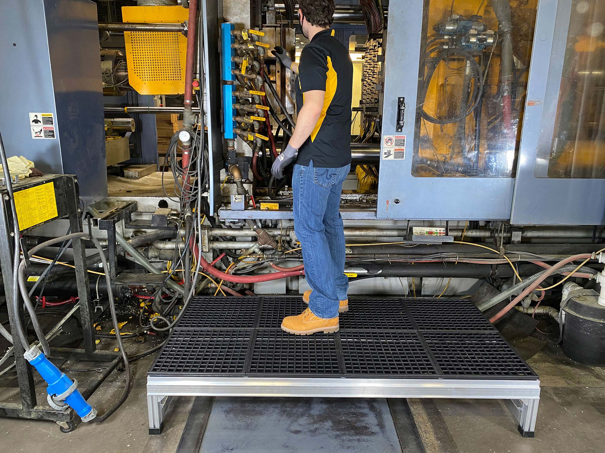 Foundation platform elevating a worker to better reach into a machine