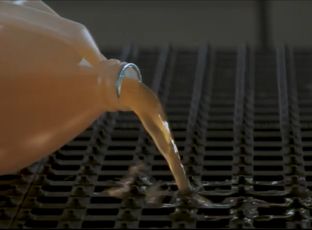 Oil spilling out of bottle onto an open surface
